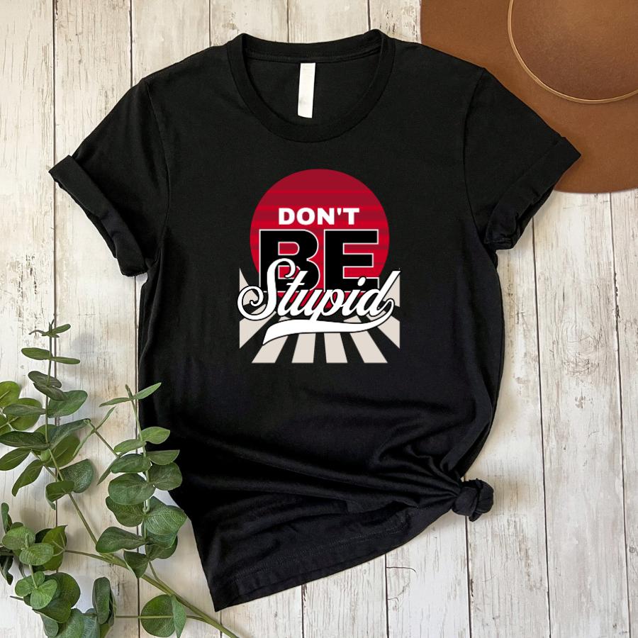 Black t-shirt with "Don't Be Stupid" graphic text and red sun design