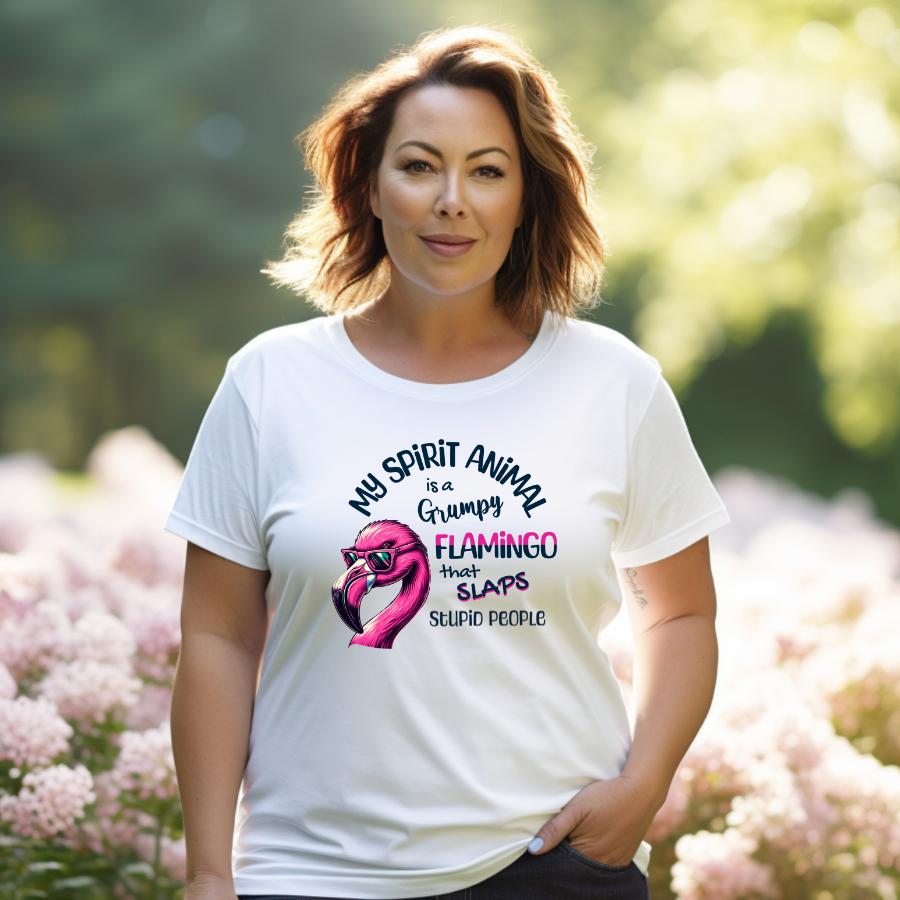 Woman wearing a white "My Spirit Animal Is a Grumpy Flamingo" graphic t-shirt outdoors