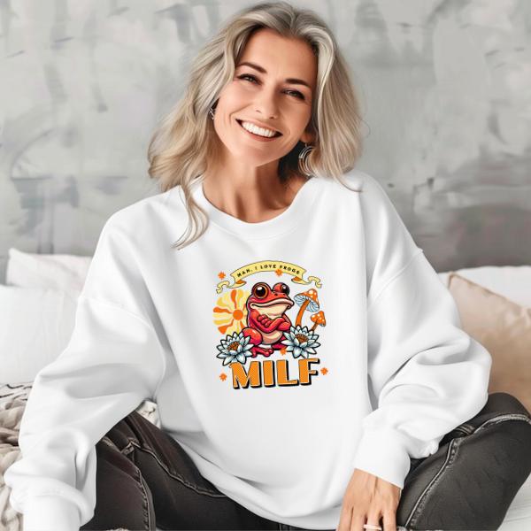 Woman wearing white "Man I Love Frogs" sweatshirt with cartoon frog and flowers design