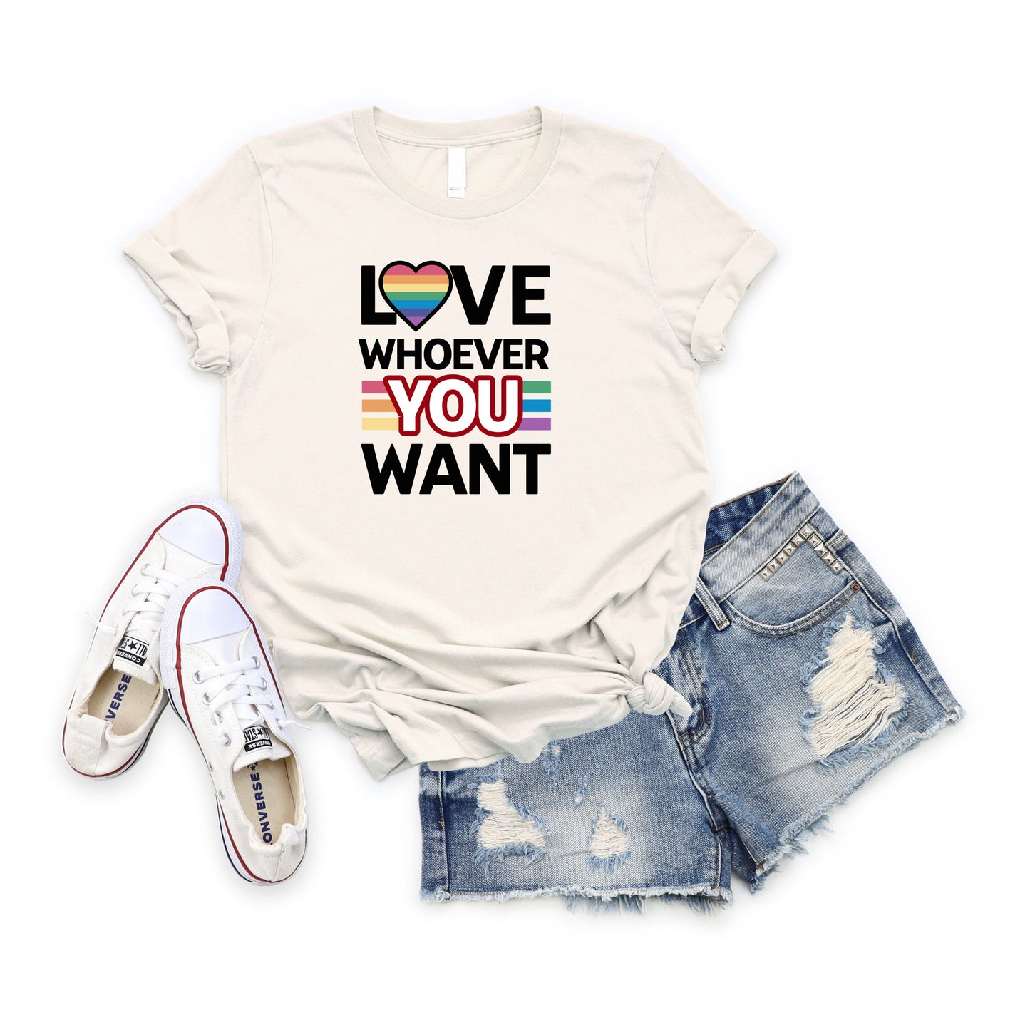 White Love Whoever You Want T-shirt with rainbow heart graphic, paired with ripped denim shorts and white sneakers