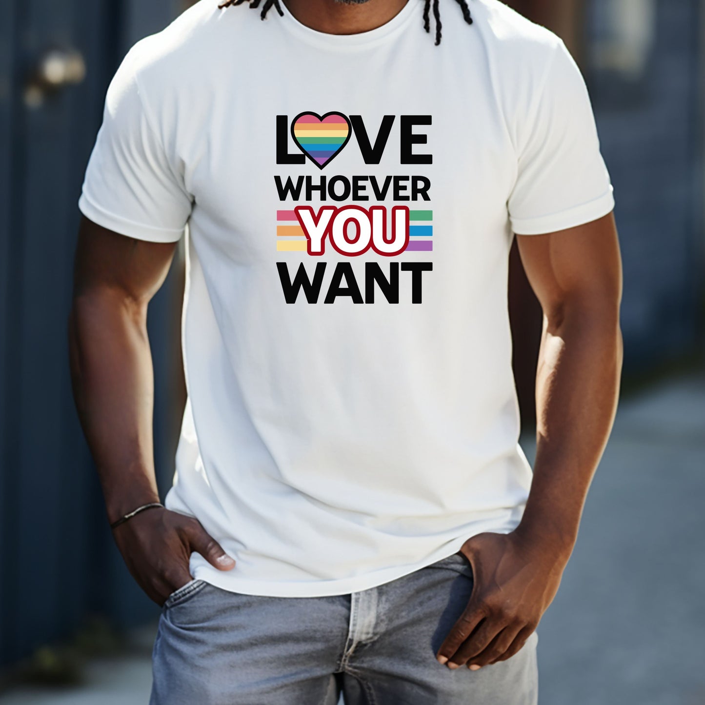 Man wearing white Love Whoever You Want T-shirt with rainbow heart and inclusive pride colors text design