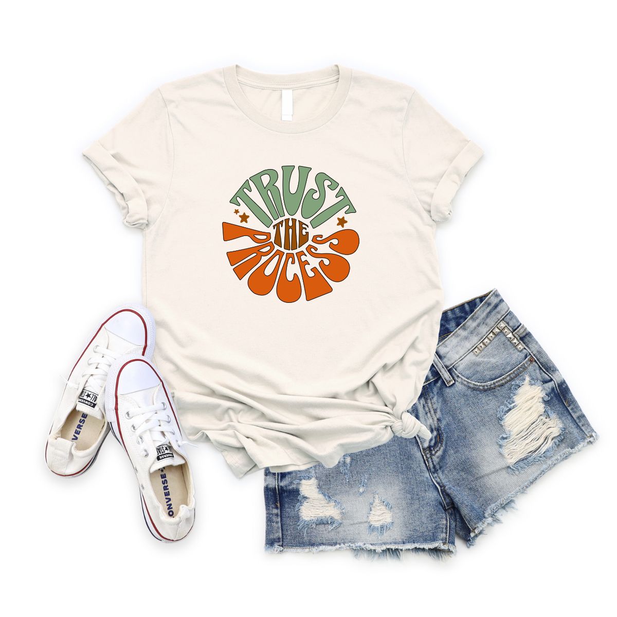 Cream Trust the Process T-Shirt with retro text paired with ripped denim shorts and white sneakers