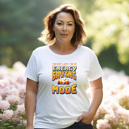 Woman wearing white Energy Saving Mode t-shirt with colorful text and battery icon outdoors