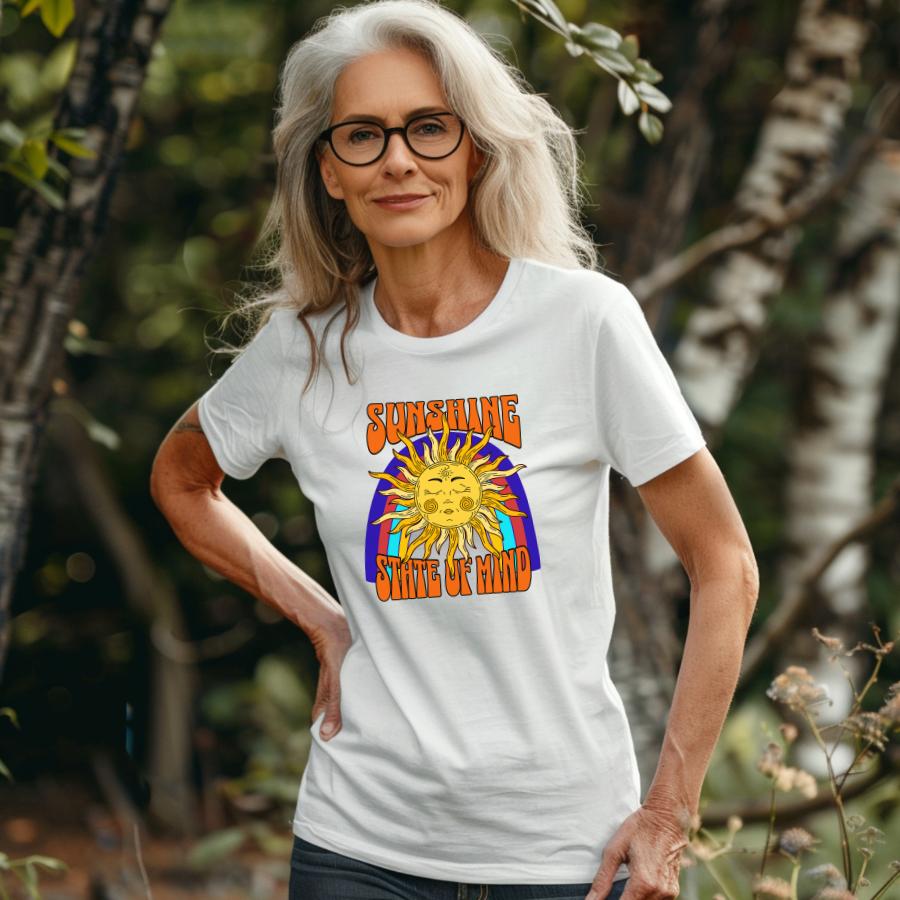 Woman wearing white Sunshine State of Mind T-shirt with sun graphic outdoors
