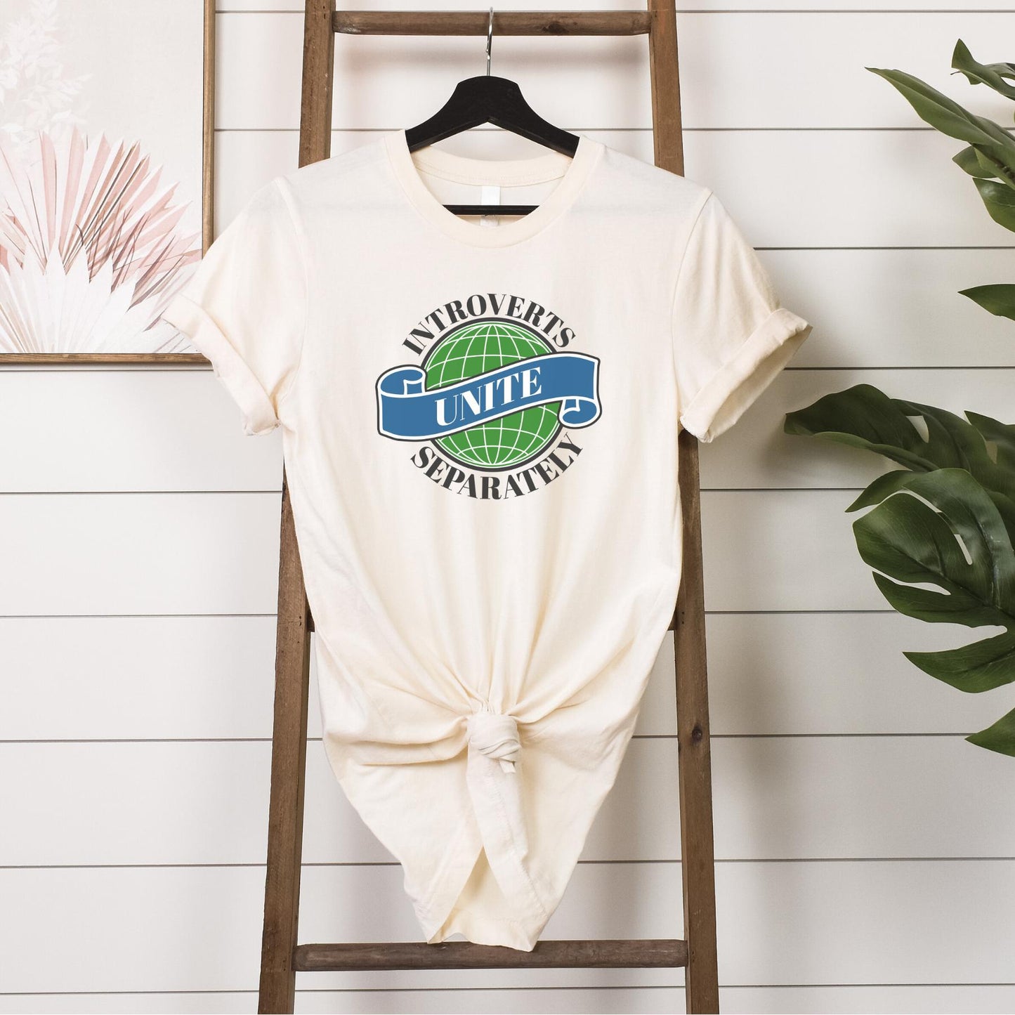 Tshirt- introverts unite separately hanging in softcream 