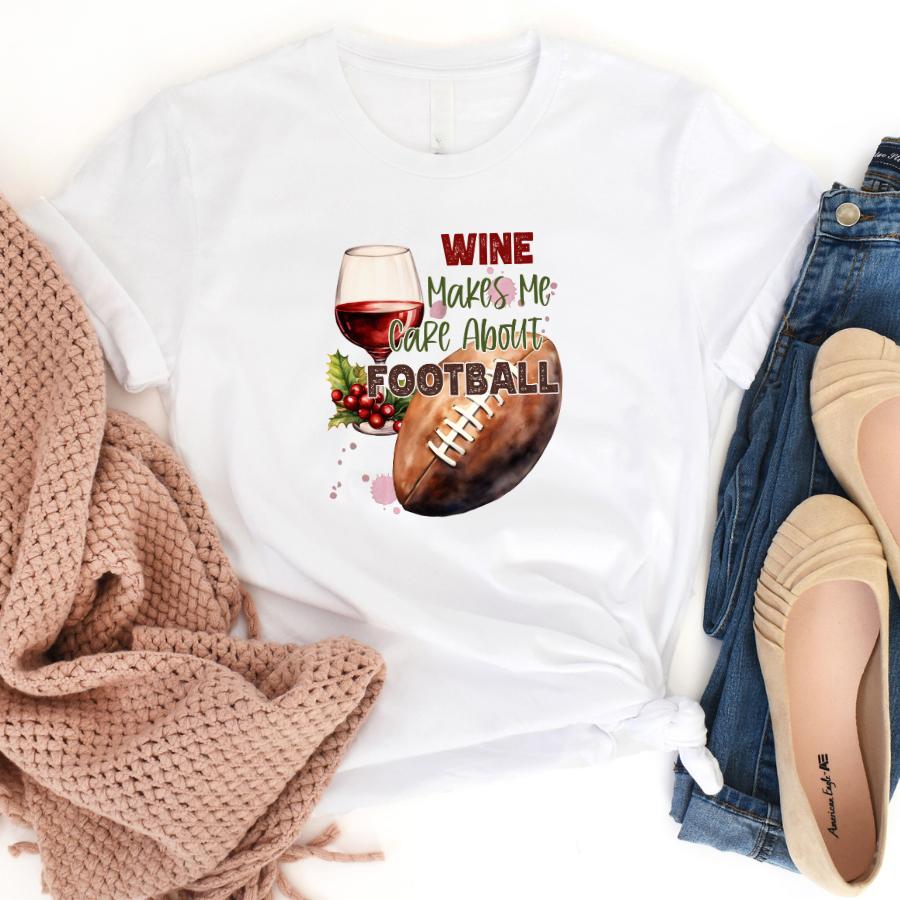 White t-shirt with "Wine Makes Me Care About Football" text, featuring a glass of red wine, grapes, and a football design.